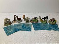 Full set of six Peter Barrett porcelain figurines, each paired with a blue booklet representing months January through June.