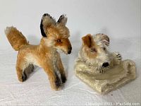 Two miniature Steiff animals - a fox and a dog puppet shown side by side on white background