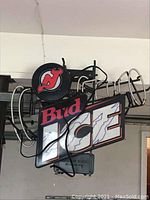 Photo of Bud Ice neon electric sign with visible neon tubing shaped around a beer can and logo.