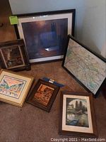 Overall photo showing five framed artworks arranged on carpet.