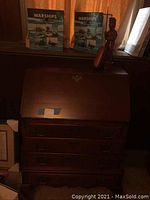 Front view of wooden secretary chest with two warship books and wooden statue on top, showing condition and size.