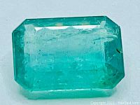 Top-down view of emerald on white background