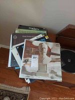 Stack of approximately 19 classical LP records including Tchaikovsky and Horowitz titles visible, album cover featuring a bust statue.
