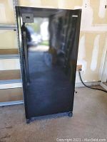 Full frontal view of the black Kenmore upright freezer showing size and condition of exterior.