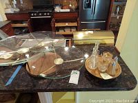 Three-tiered revolving serving trays on a kitchen counter with other items visible in the background.