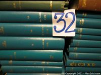 Photo shows many bound volumes of The New Yorker magazine in green hardcover bindings stacked horizontally and vertically, with gold embossed text on spine indicating year and volume number.