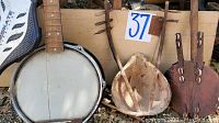 Photo of First Act banjo, coconut shell drum and stringed instrument with shell decoration
