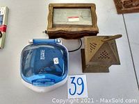 Small wooden glass frame, wooden incense burner house-shaped, and blue digital clock in box.