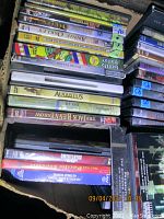 Stack of assorted DVD movies including historical dramas and classic films, showing titles like Augustus and The Jack Benny Show.