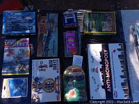 Top-down view of toy collection including Anti-Monopoly board game, airplane model kits, and boxed items