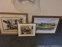 Overview of the three framed wall art pieces arranged against a wall showing their relative size and style