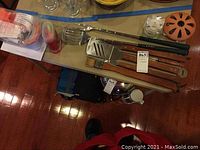 Top-down view of the outdoor cooking tools and ice pop maker on table.