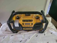 Top front view of DEWALT DC012 charger/radio with control panel and protective metal handles visible.