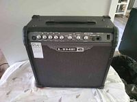 Front view of Line 6 Spider III 30 watt guitar amplifier showing speaker grille and control panel on top.