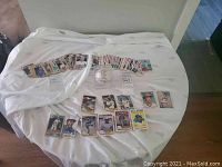 Collection of 1984 Montreal Expos baseball cards spread on a table including Gary Carter and Tim Raines cards with a signed baseball visible.