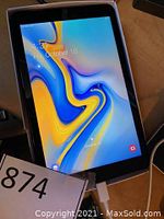 Front of tablet powered on in box