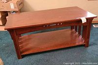 Front view of oak coffee table with lower shelf and integrated buttons on one side