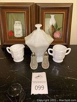 Photo showing white glass creamer and sugar container, glass salt and pepper shakers, and two framed painted glass pictures.