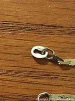 Close-up photo of the 14k gold marking on the chain necklace clasp