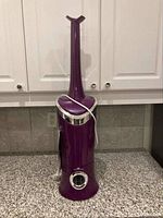 Full view of purple Air Innovations humidifier showing its overall shape and cord wrapped around the base.