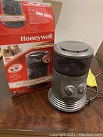 Honeywell 360 Degree Surround Heater with original product box showing the heater's design and packaging.