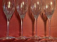 Five crystal wine glasses standing side by side showing the cut crystal design on the bowls and their shape
