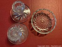 Top view of two crystal candle holders and one crystal ashtray showing patterns and overall condition.