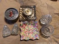 Photo of entire lot with salt and pepper shakers, clock, candle holder, floral dish, and Royal Doulton figurine in box