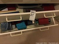 First drawer view showing multiple jewelry boxes and pouches in plastic container