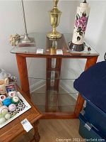 Photo showing full view of glass stand with wooden frame and items on top for scale (not included).