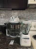 Nutrichef halogen oven and Osterizer blender on kitchen counter showing full view of devices