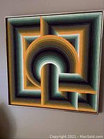 Full-frontal view of 31×31 in framed textile artwork showing complete abstract geometric design
