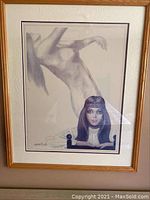 Framed art print showing a nude female figure in an expressive pose with visible details of the figure's anatomy and pose.