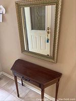 Front and side view of wood hall table and wall mirror showing overall condition and style