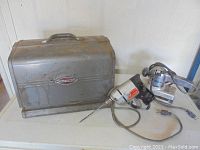 Photo of three older power tools: drill, circular saw, router, plus metal carrying case marked Craftsman.