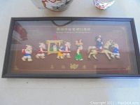 Framed Korean Wedding March art with colorful figures in relief under glass in dark wood frame