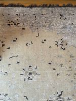 Close-up showing the subtle faded star jasmine floral pattern on cream and ivory background with dark scattered accents and the short fringe edge.