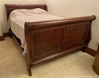 Full view of queen sleigh bed showing footboard and side rail