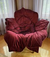 Front view showing deep cushioning, tufted floral back design, padded arms