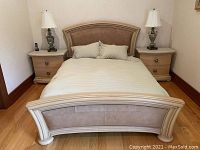 View of the bed showing the footboard and headboard with suede upholstery and wooden frame