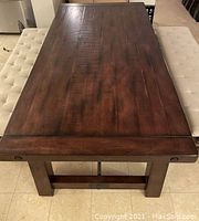 Overhead view from one end showing full table top, base and finish.