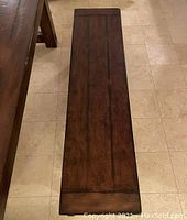 Top view of wooden bench seat showing surface texture and finish