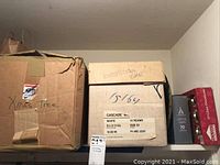 Boxes stacked on a shelf marked with labels such as 'Xmas Tree', 'Battery Operated Lights', 'Cascade', and 'Ornaments'