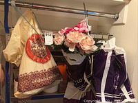 Photo shows a bundle of light pink faux flowers in wrapping along with hanging bags.
