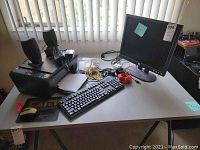 Dell 19-inch monitor, HP DeskJet F4480 printer, keyboard, speakers, cords, mouse with pad on a white table.