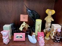 Photo showing a variety of vintage Avon collectibles including ceramic animal and character figurines and perfume bottles, some in original boxes.
