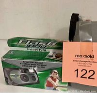 Fujifilm Flash 1000 disposable camera box, unopened, featuring product image and branding. Auction lot tag partially visible.