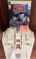 Top front view of the Star Wars Rebel Snowspeeder with Star Wars comic behind it and auction tag visible.