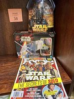 Photo showing all three items: Star Wars Senator action figure in packaging, Sith Speeder vehicle box with Darth Maul figures, and People Star Wars Stars Collectors Edition magazine.