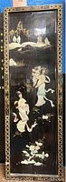 Full view of the tall rectangular black panel with gold Asian figures and landscapes, showing overall shape, border, and condition.